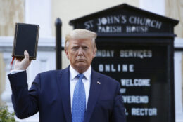 Trump holding upside down Bible